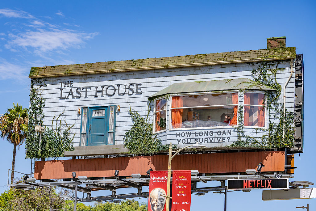 A live performer is seen inside a Netflix billboard above the Sunset Strip to promote "The Last House" on August 07, 2026 in Hollywood, California