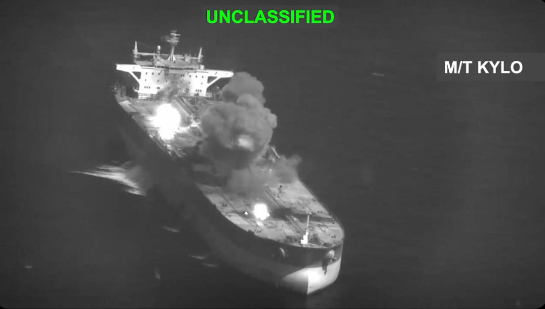 A black and white still from US footage of a tanker being hit with 'unclassified' written in green along the top