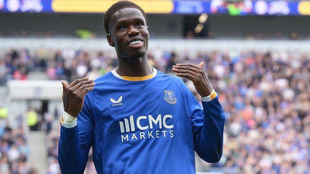 Thierno Barry, in blue kit, celebrates with a beckoning gesture after what he thought was his second Everton goal of the afternoon - but it was disallowed