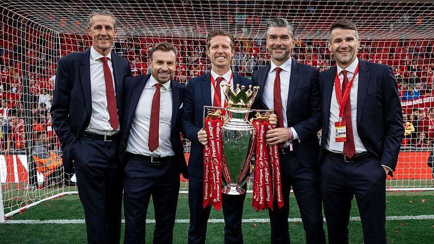 Barry Hunter, Julian Ward, Michael Edwards, Richard Hughes and David Woodfine pose for a photograph with the Premier League trophy at the end of the 2024-25 season.