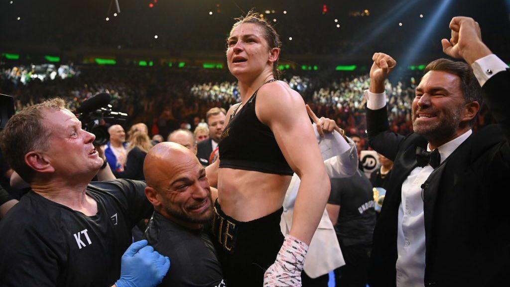 Katie Taylor celebrates with manager Brian Peters, trainer Ross Enamait and promoter Eddie Hearn.