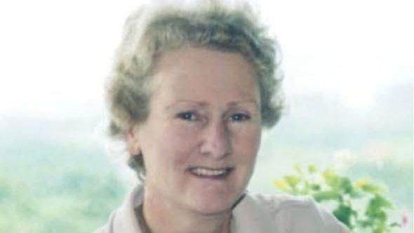 Doreen Morris wears beige and her hair has curls