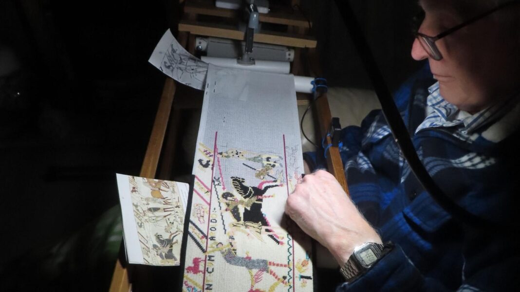 Bayeux Tapestry unveiled to UK public for first time at British Museum A man with glasses works away on a cross-stitch replica of the Bayeux Tapestry