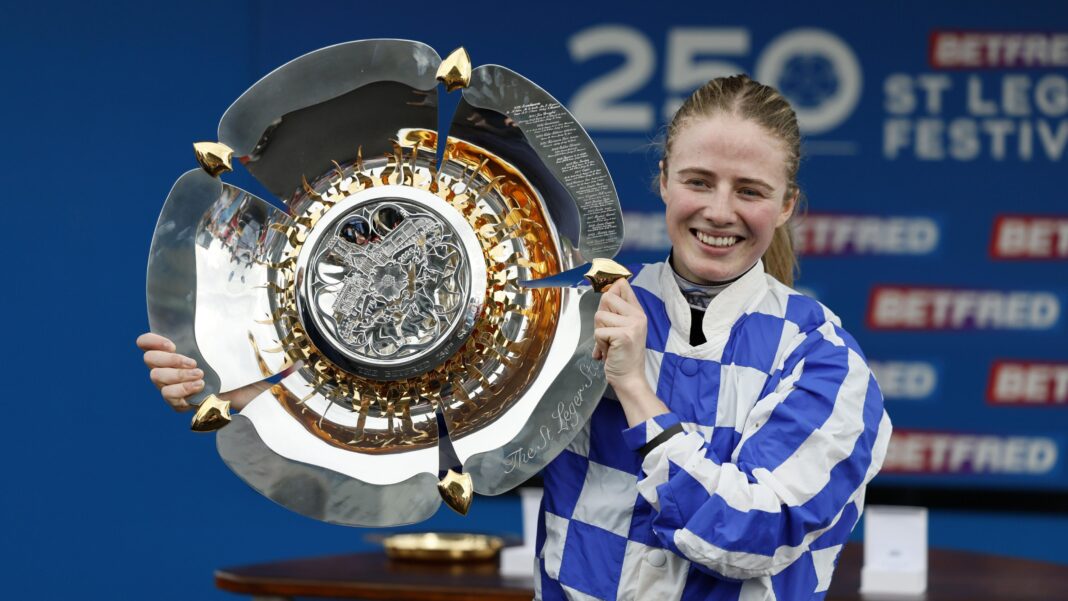 St Leger win has removed Osborne’s fear of failure Saffie Osborne, in blue and white-checked silks, holding a silver trophy to her right
