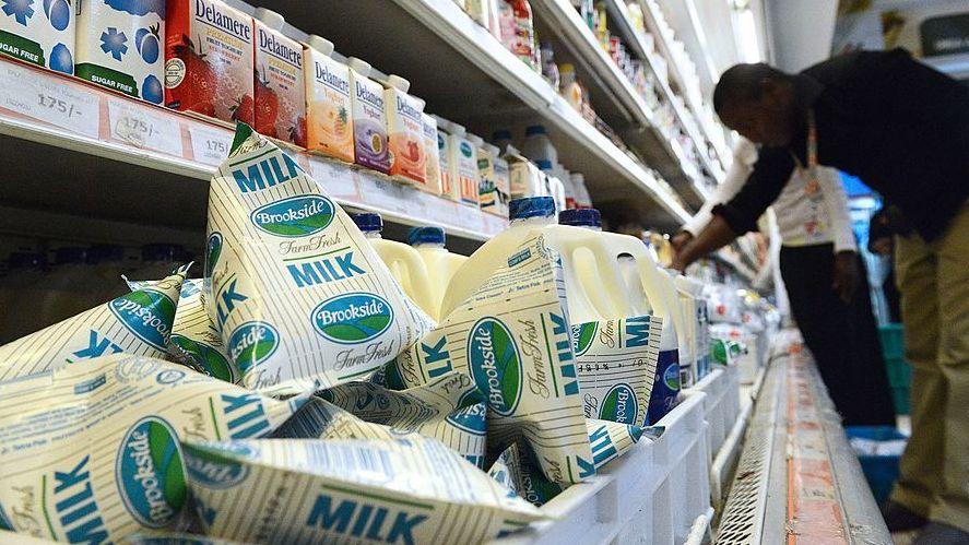 A consumer shops for Brookside dairy milk products in a supermarket