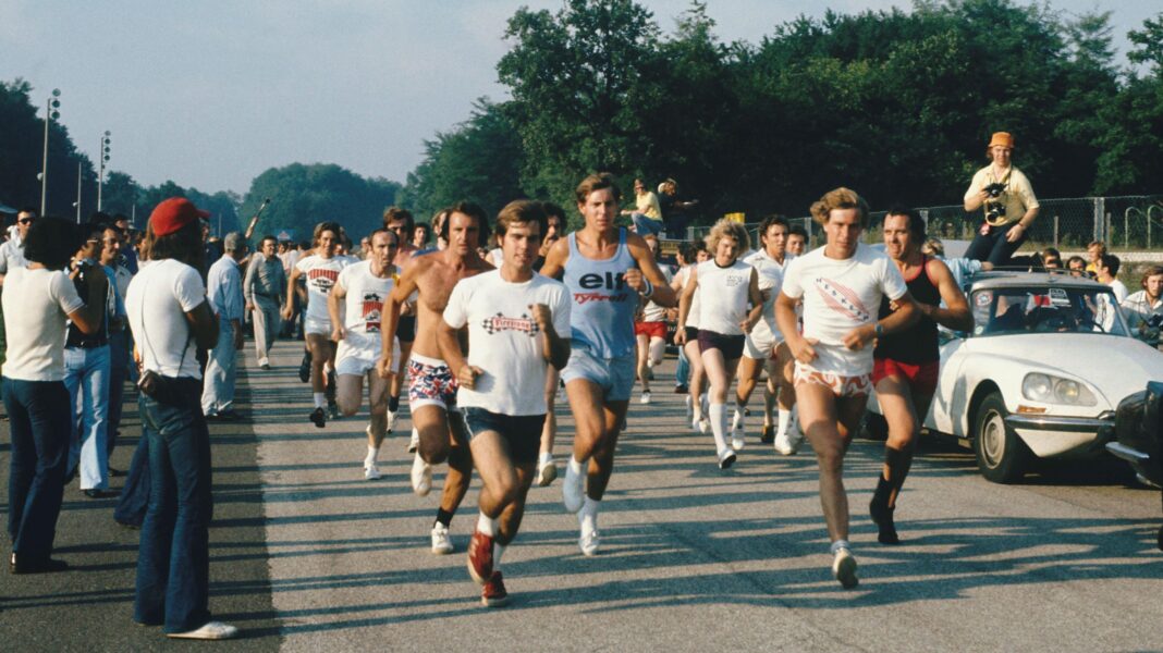 Drivers and team members take part in a track run at the 1973 Italian Grand Prix