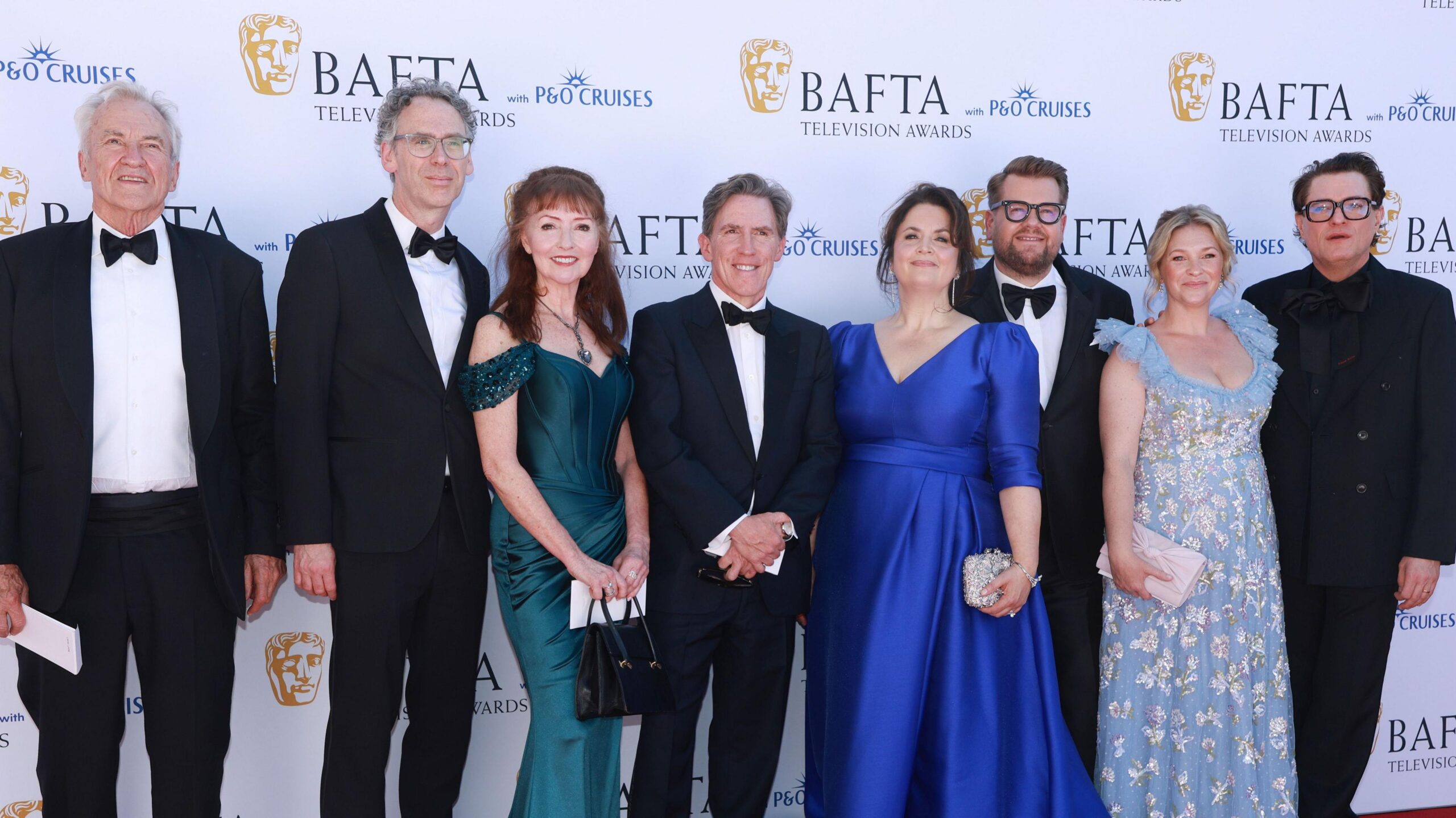 The cast of Gavin and Stacey at the BAFTAs- Robert Wilfort, Melanie Walters, Rob Brydon, Ruth Jones, James Corden, Joanna Page and Mathew Horne  Brydon wears a black suit, whit shirt and black bow tie.