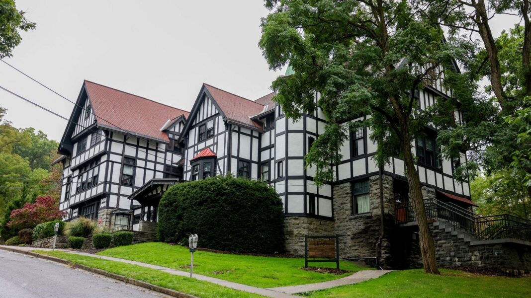 Exterior of Cornell University’s Chi Phi fraternity house showing a white building with mock tudor style black details, in Ithaca, New York, US, September 29, 2026.