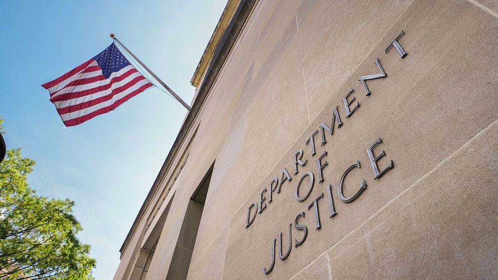 A sign marks the location of the U.S. Department of Justice (DOJ) headquarters building on April 30, 2025, in Washington, DC