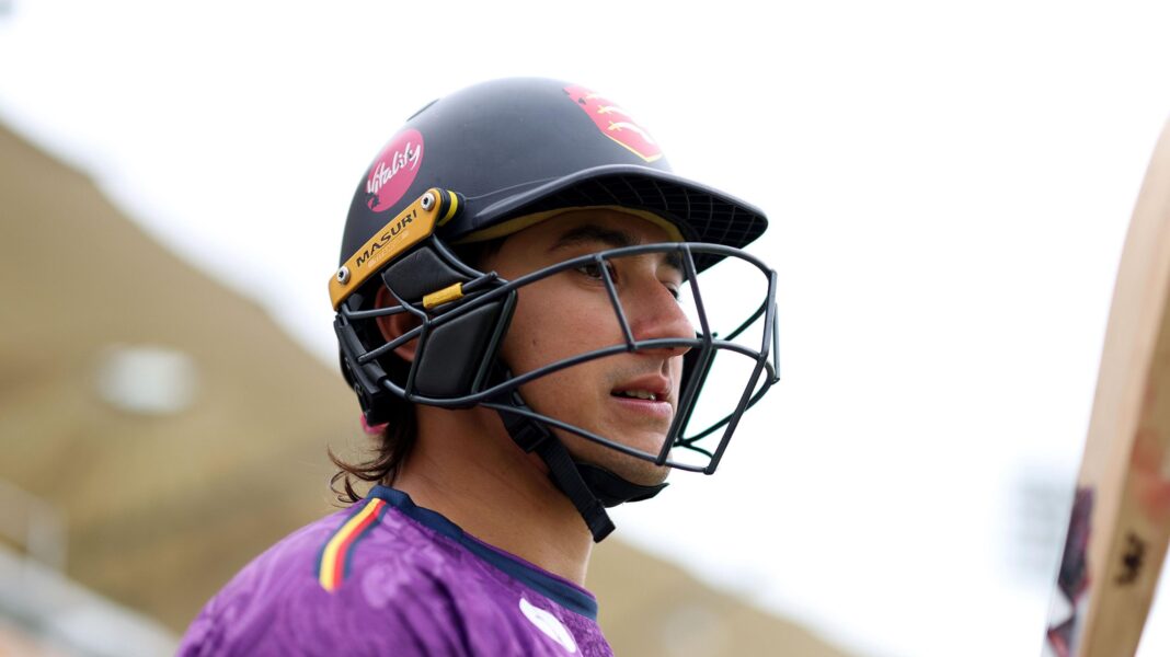 Essex cricketer Das charged with two counts of rape Robin Das wearing a black cricket helmet, carrying a cricket bat and wearing a purple top