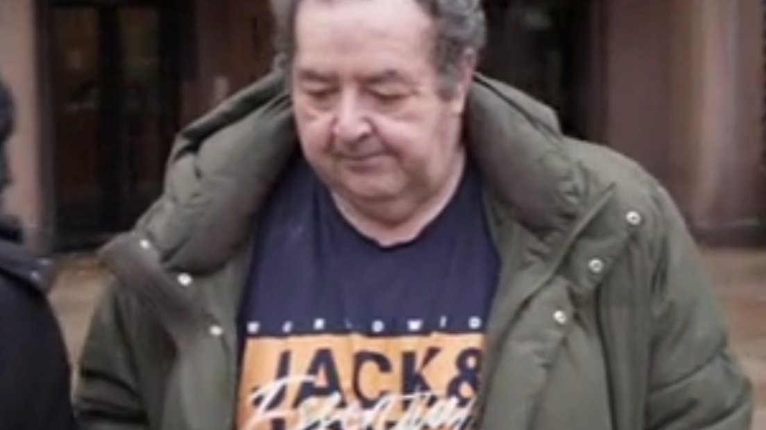 Gerard Woodhouse, who is middle-aged with thinning grey hair, is seen leaving Liverpool Magistrates' Court in December. He is wearing a blue t-shirt with a brand logo on it, and an olive green puffer-style jacket