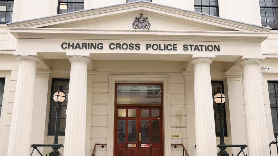 The front of Charing Cross police station, with the name of the station visible above the door on a Roman style entrance