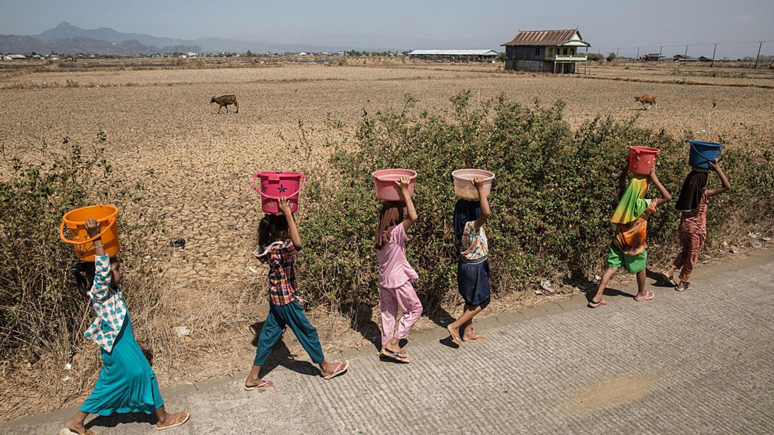 Women walking a long a road in Indonesia during the 2015 El Niño