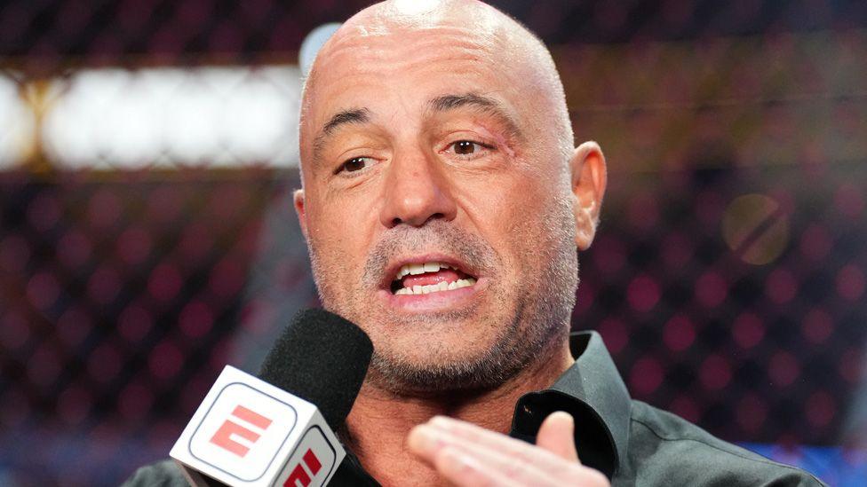 Joe Rogan speaking into a microphone