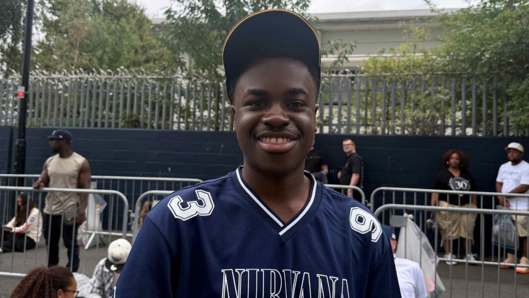 Prince Dean Sithole wears a navy jersey and baseball hat.