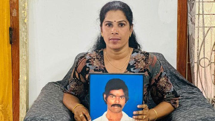 Jeyaruby Jeyabalan holds a photograph of her father.