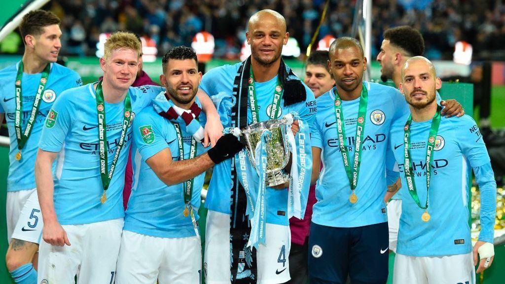 Kevin de Bruyne, Sergio Aguero, Vincent Kompany, Fernandinho, and David Silva pose while celebrating with the EFL Cup after Manchester City's 3-0 victory over Arsenal