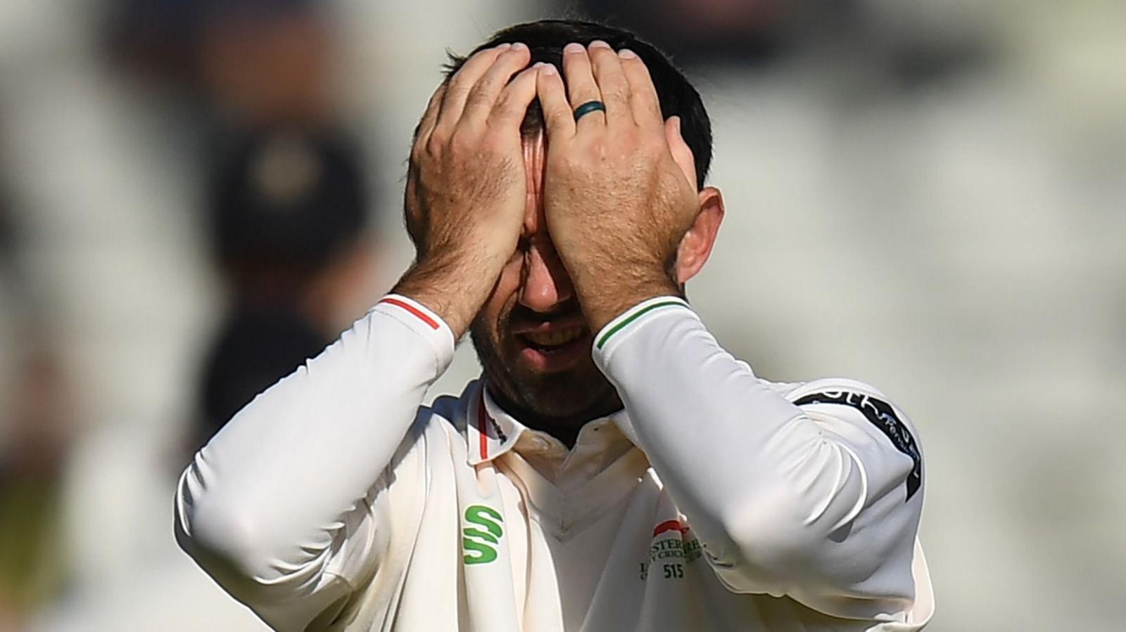 Ian Holland of Leicestershire reacts by raising his hands to cover much of his face during his team's County Championship match against Warwickshire, in which they were relegated