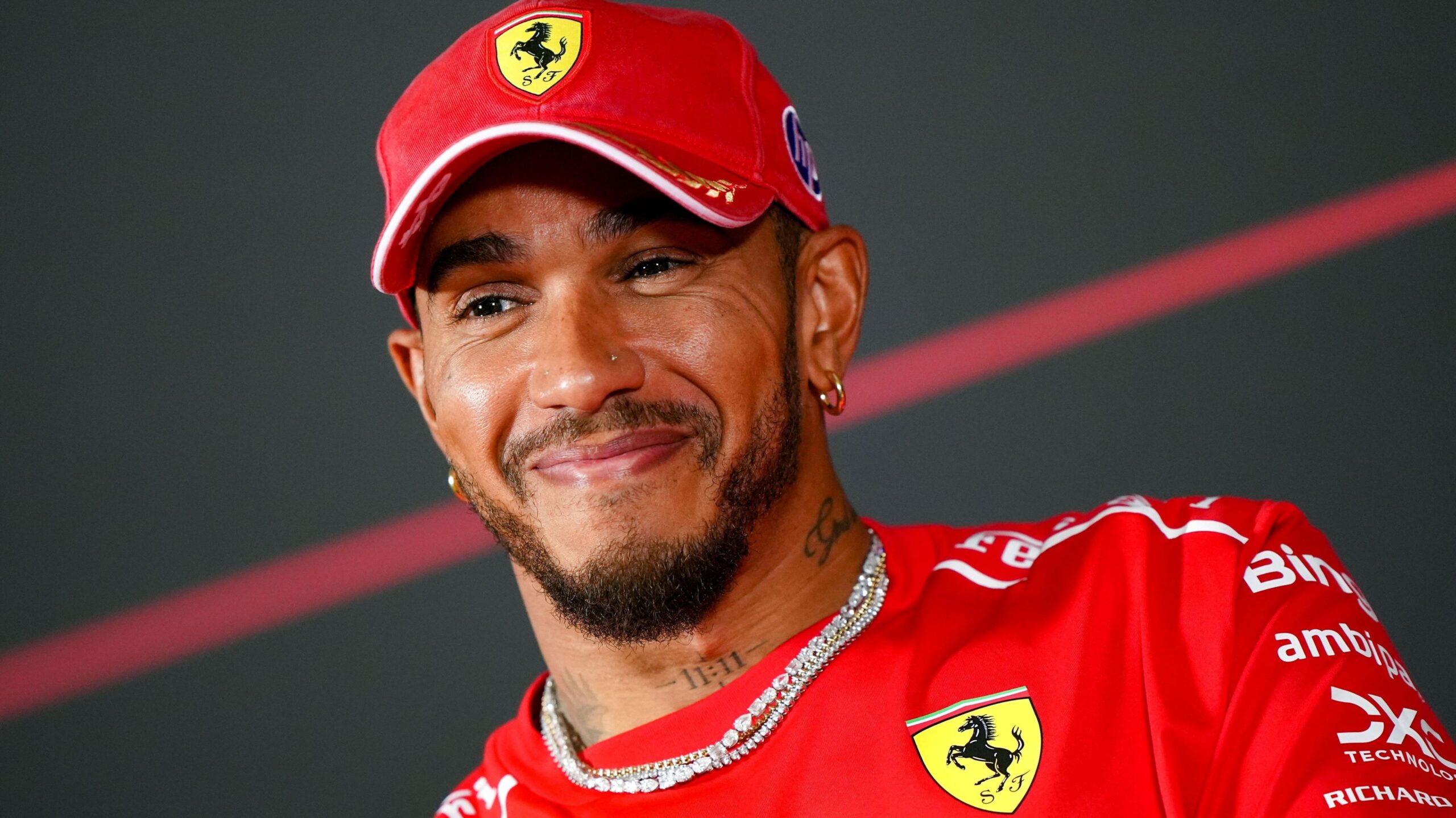 Ferrari's Lewis Hamilton smiles during an official news conference before the Italian Grand Prix