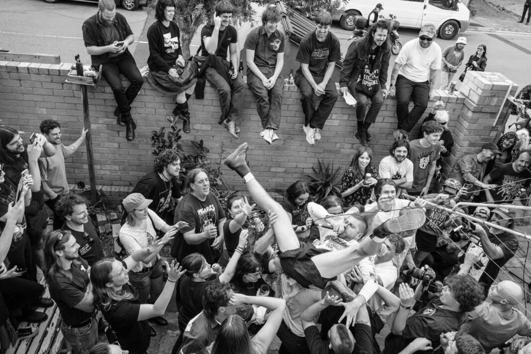 Private function at Gold Street, a crowd of people hold up Chris Penney