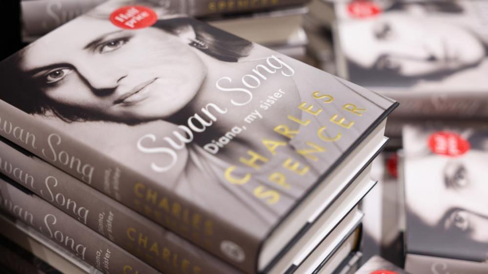 Piles of the book Swan Song: Diana, My Sister which has a grey cover with a picture of Princess Diana on it