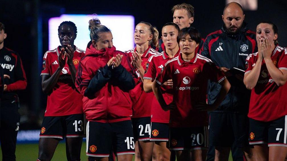Manchester United players react at full-time