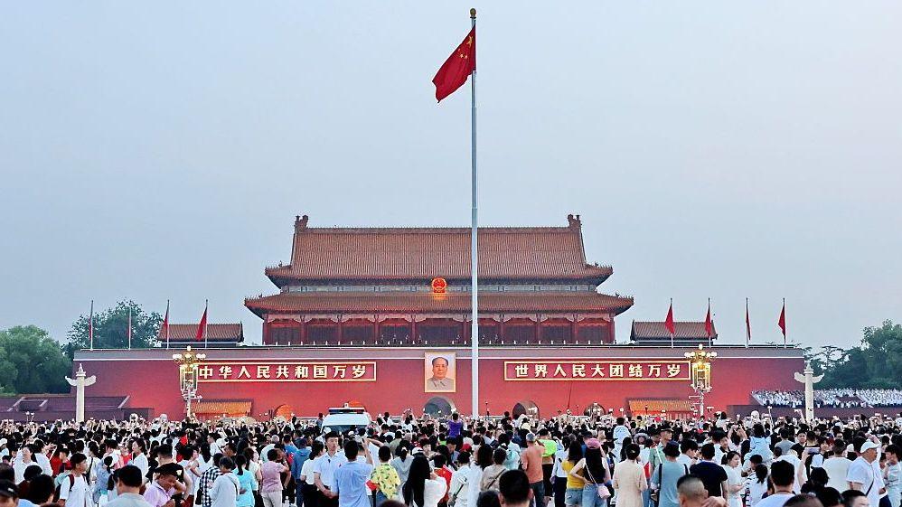 Crowds gather at Tiananmen Square to watch a flag-raising ceremony on July 1, 2026 in Beijing, China