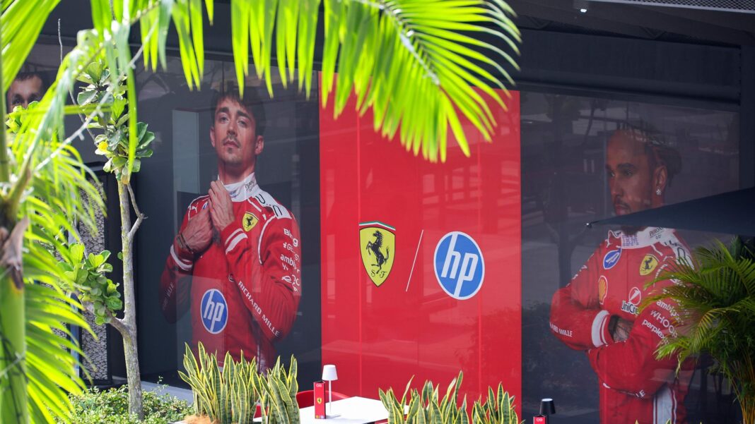 Ferrari's paddock base at the Bahrain Grand Prix with photos of Charles Leclerc and Lewis Hamilton