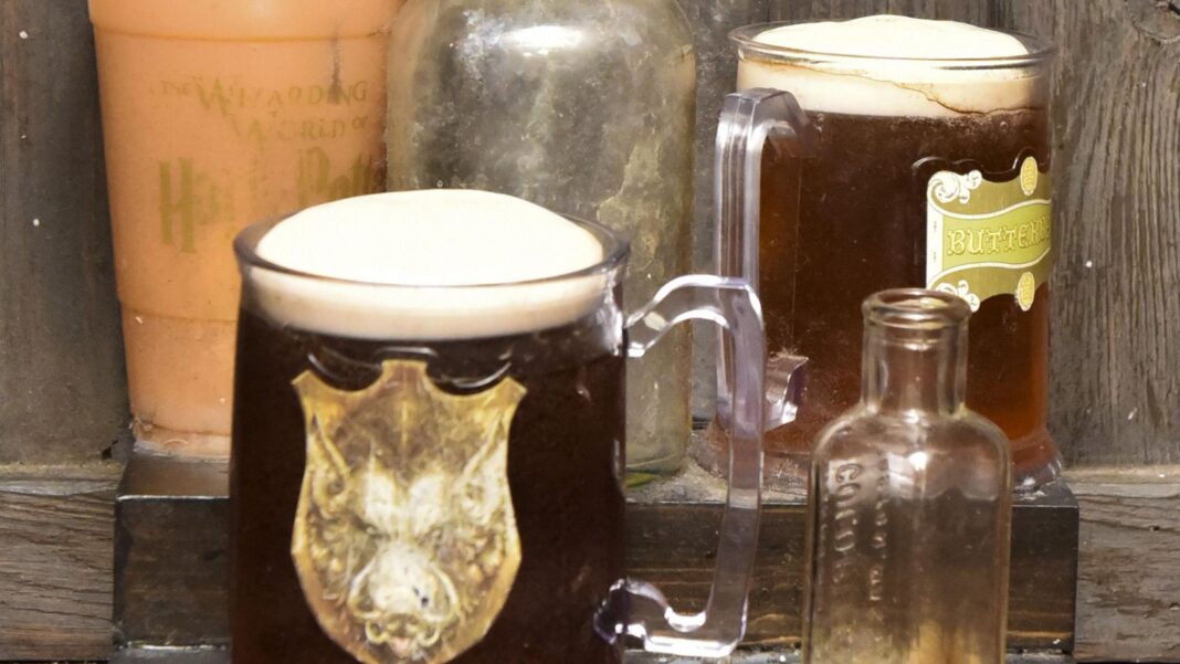 Harry Potter and the goblet of no booze Two large glasses of a dark-coloured frothy drink have been placed on a table alongside two empty glass bottles and a large cup. They have Harry Potter branding on them.