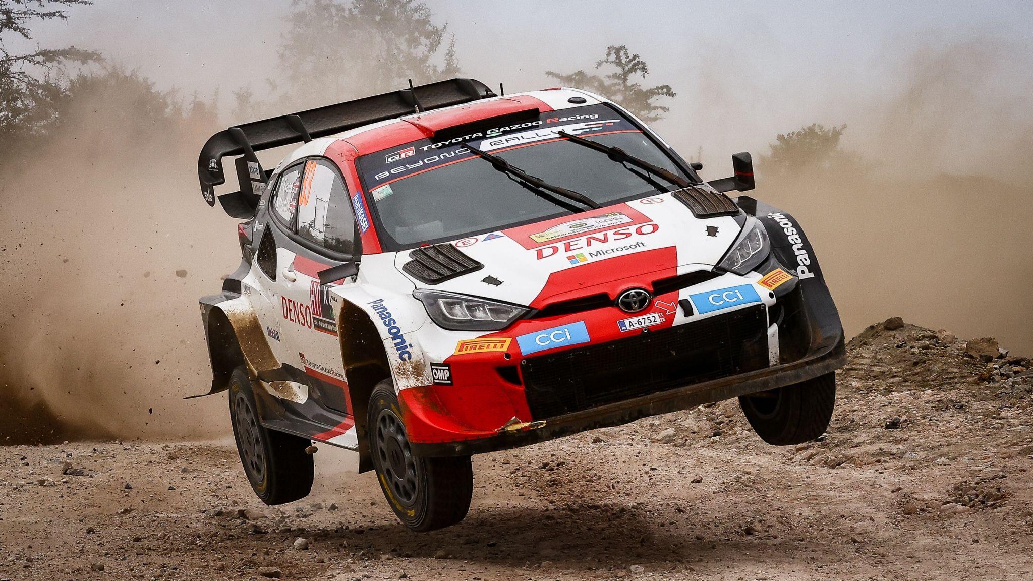 Elfyn Evans' red and white Toyota Yaris leaves the ground on a dirt track in Kenya