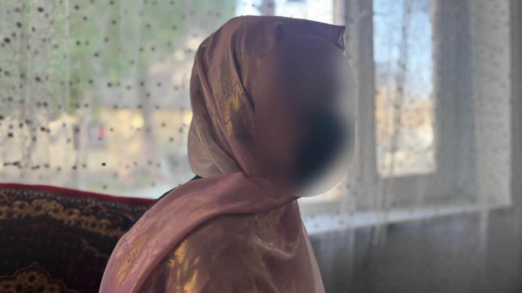 ‘Complete despair’: Afghan female medical students fear being sent home from Pakistan A girl sits in front of a window wearing pink