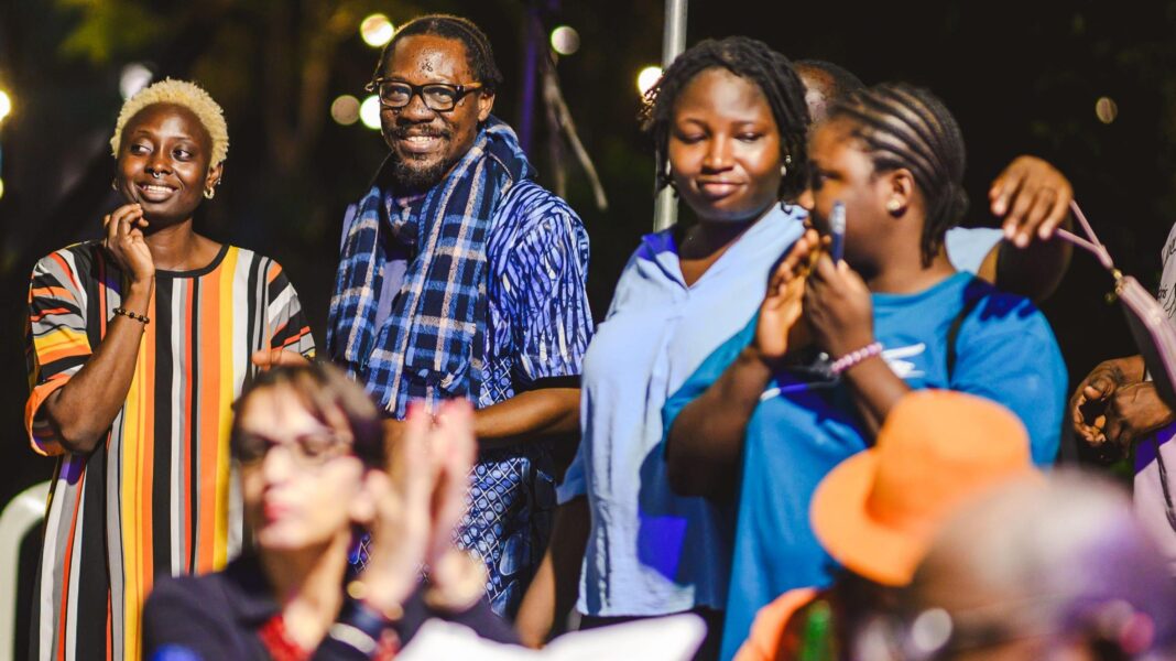 Crowds in Lagos - men and women and some with phones - watching Ben Dancer non-stop performance