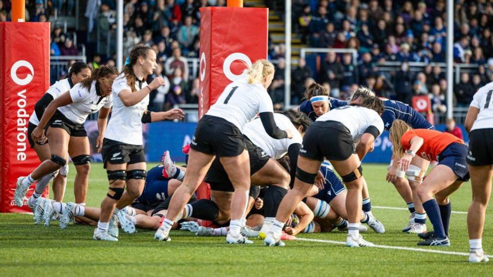 Evie Gallagher scores a try for Scotland against New Zealand