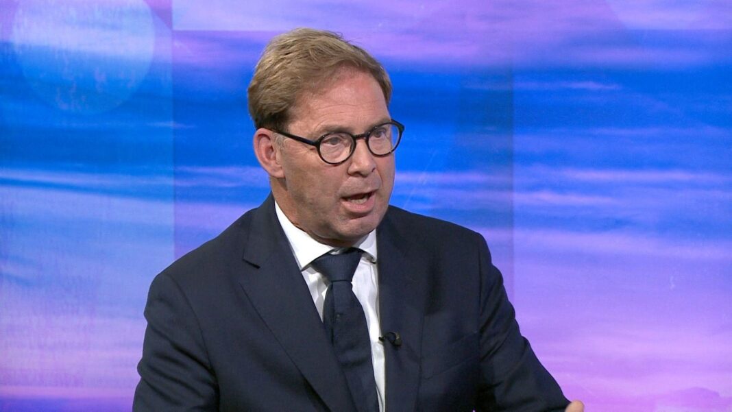 MoD withheld information about nuclear test veterans’ records, ex-minister claims A man in a navy suit and tie speaks to someone off camera in front of a purple and blue screen on TV.