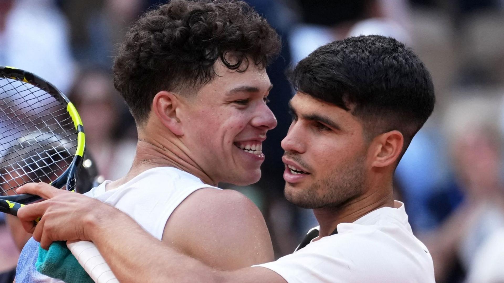 Ben Shelton and Carlos Alcaraz hug after their 2025 French Open match