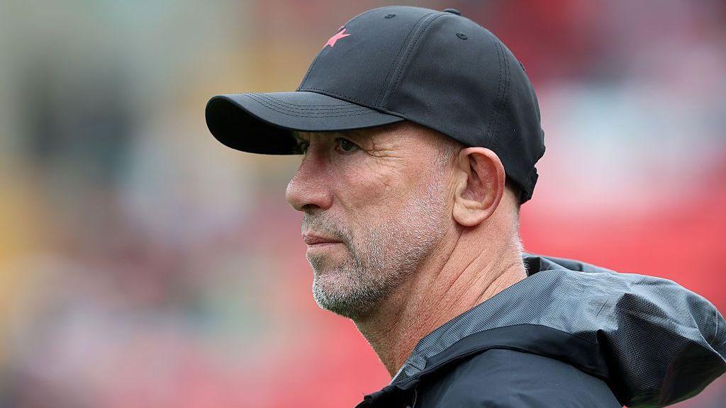 Brendan Venter in dark coat and cap