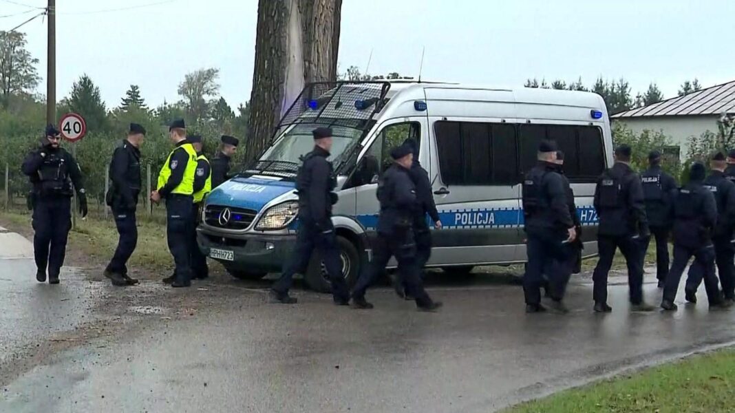 Poland says fire at Starlink station is sabotage as Denmark warns of rising Russian threat Police walk next to a silver police van near the telecommunications station in Wola Krobowska, Masovian Voivodeship province.