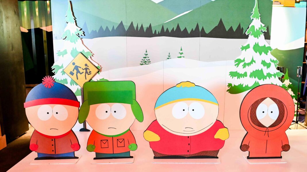 Characters from South Park TV show as cut-outs on a stage with a wintery backdrop.