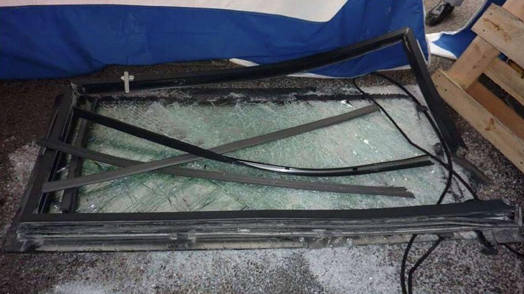 Firm fined £1m after man killed by falling window A large broken window is lying on the floor
