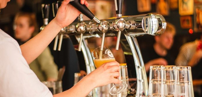 beer being poured in pub
