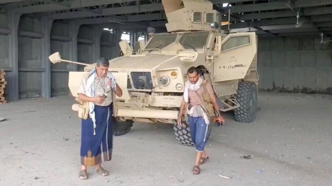 Screengrab of a video from Houthi-run Al Masirah TV showing an armed man walks next to an armoured vehicle in Mocha, Yemen, after the Houthis reportedly seized the Red Sea port city (10 September 2026)