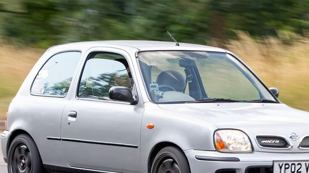 A general view of a silver 2002 Nissan Micra on a road