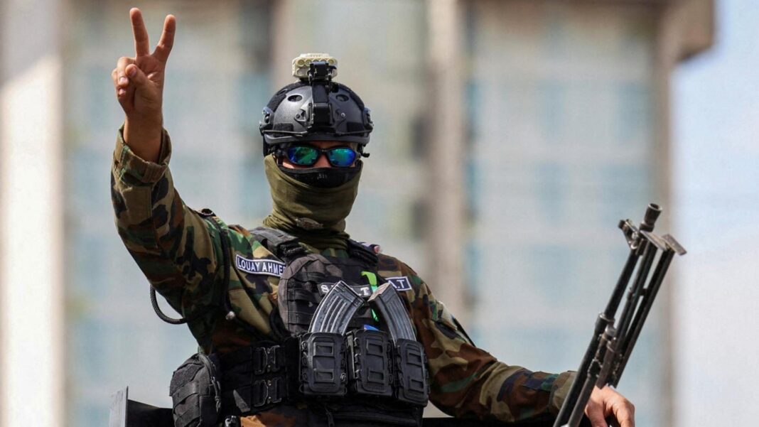 Last UK and US troops leave Iraq as anti-Islamic State mission ends A member of the Iraqi security forces gestures as he travels in a convoy through Baghdad, Iraq (30 September 2026)