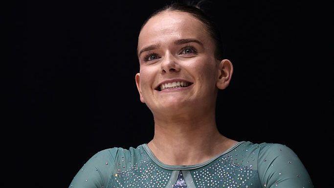 Alice Kinsella in a teal coloured leotard competing at the British Artistic Gymnastics Championship.