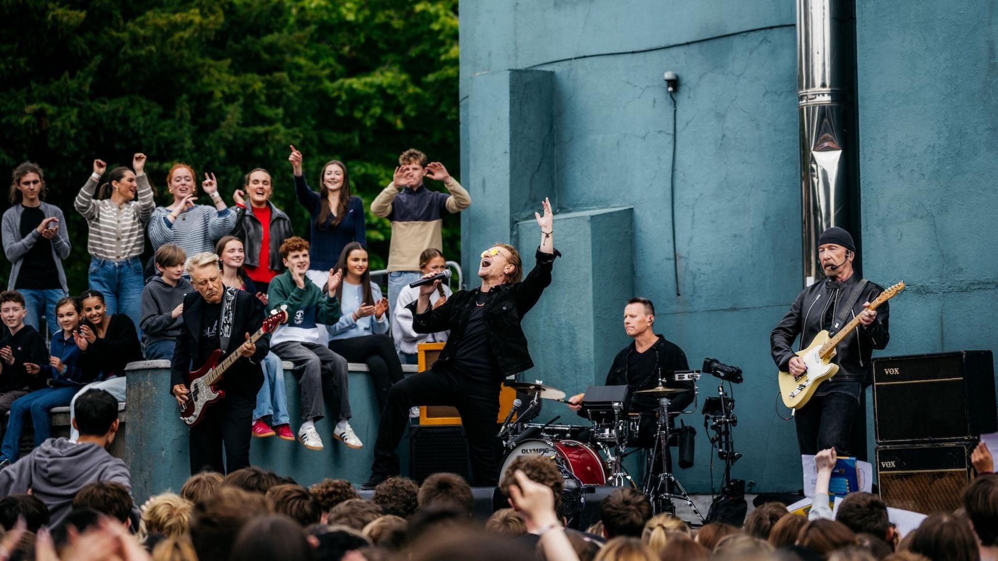 U2 on stage at Mount Temple School