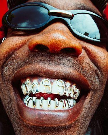 The OGM from New York rap duo HO99O9, grinning while showing off his grills