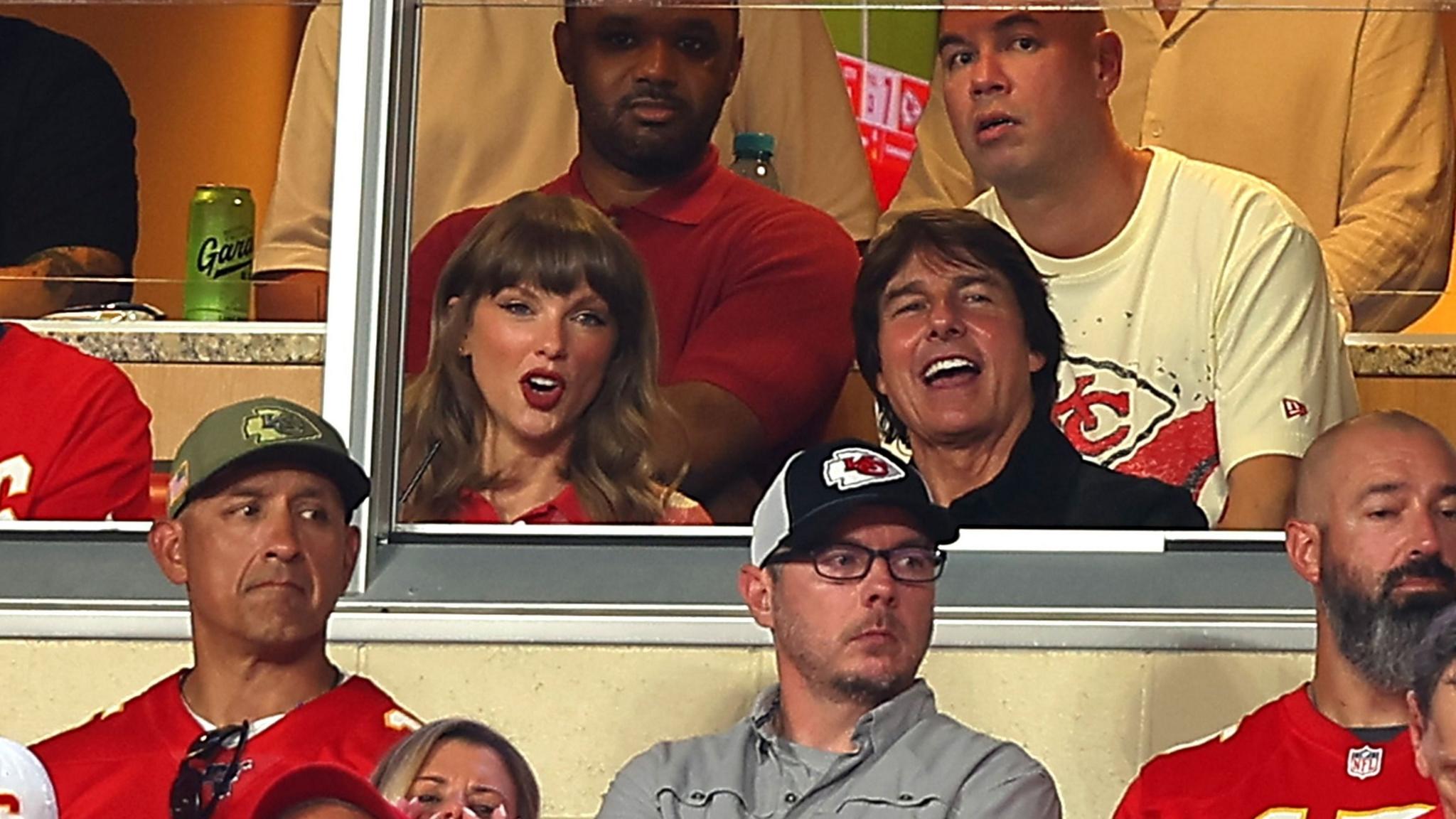 Singer Taylor Swift and actor Tom Cruise watch the game between the Kansas City Chiefs and the Denver Broncos at Arrowhead Stadium