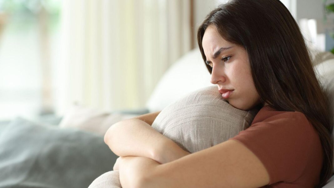 Gloomy forecast for tenants as rent rises set to speed up Disappointed looking young woman hugs a cushion.