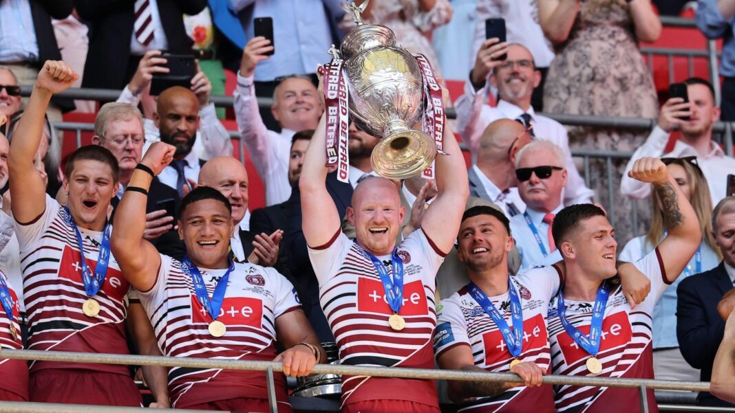 Liam Farrell (centre) lifting the Challenge Cup at Wembley in May after Wigan beat Hull KR