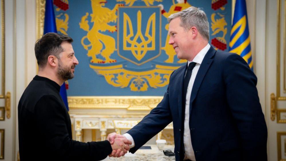 Hegseth is shaking up the Pentagon as the US wages war – but at what cost? Ukrainian President Volodymyr Zelensky, left, shakes hands with US Secretary of the Army Dan Driscoll in Kyiv, Ukraine in November 2025